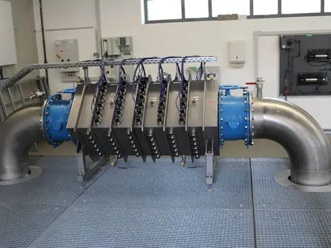 A UV water disinfection unit on large stainless steel pipes