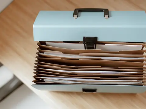 Papers kept together in an open file box